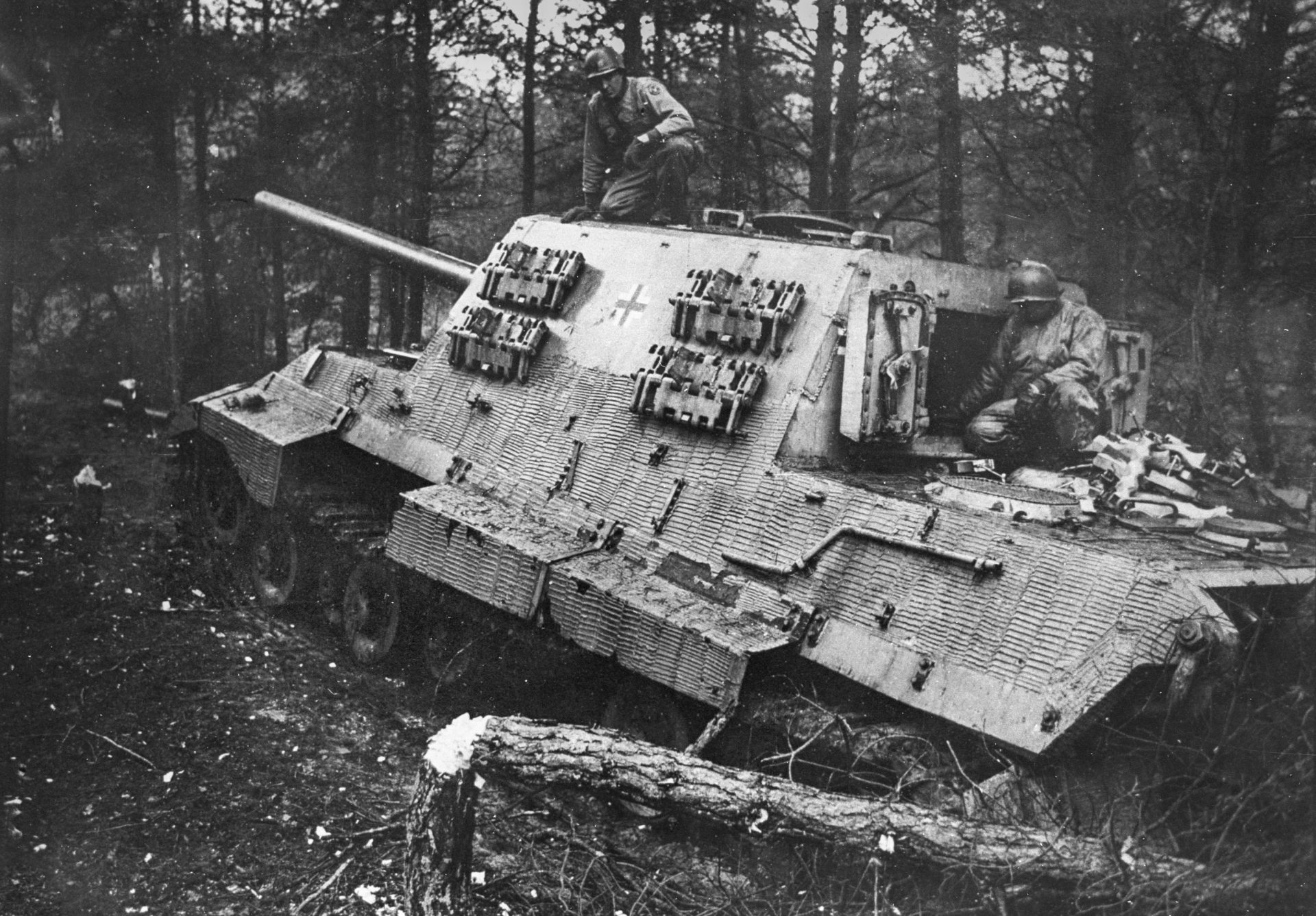 NEW-Jagdtiger_EDIT Black and white photograph of the Jagdtiger in a wood, with two men on top of the tank.