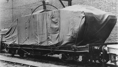 3 A black and white image of tanks on the back of a trailer, wrapped.