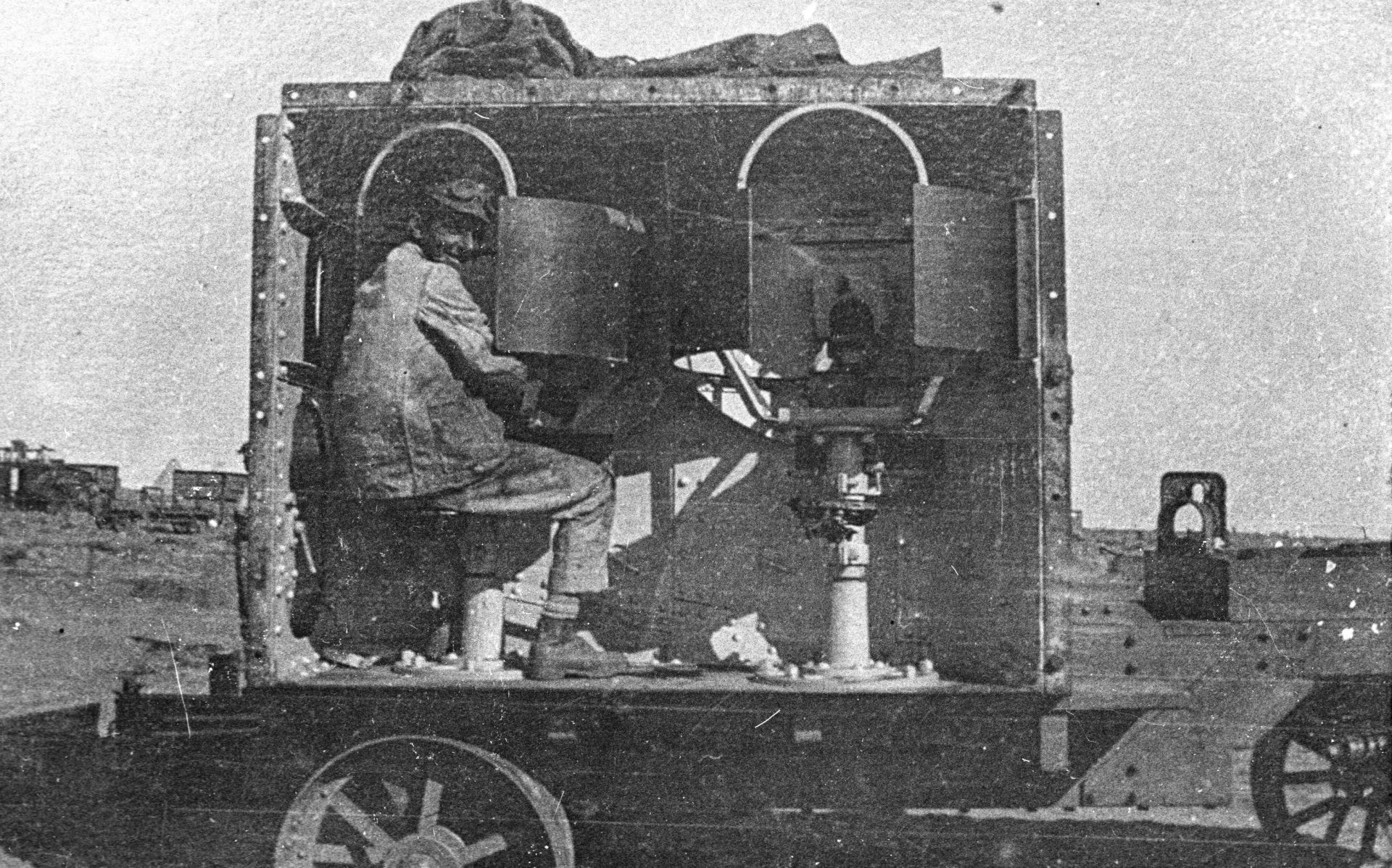 Gunner-in-female-sponson-mark-i-0518-G3 A black and white image of a gunner in a Mark I.