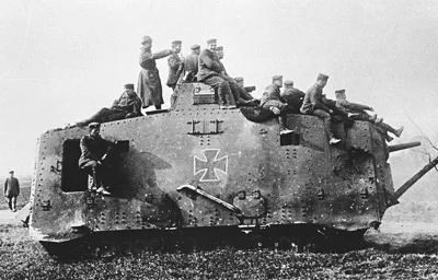 A7V-1669-B3 A black and white image of a A7V tank with crew sitting on top.