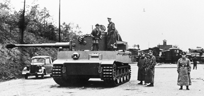 First tigers 501 502 A black and white image of Tiger 131 with uniformed men stood around and on top of the tank.