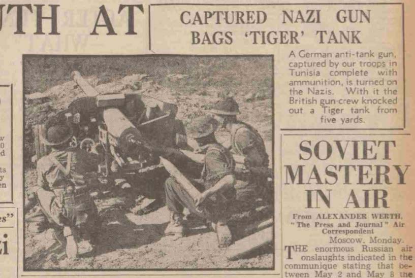 Second Newspaper Clipping. A black and white image of a news paper clipping with soldiers loading a gun and the words 'captured Nazi Gun bags 'Tiger' Tank'.