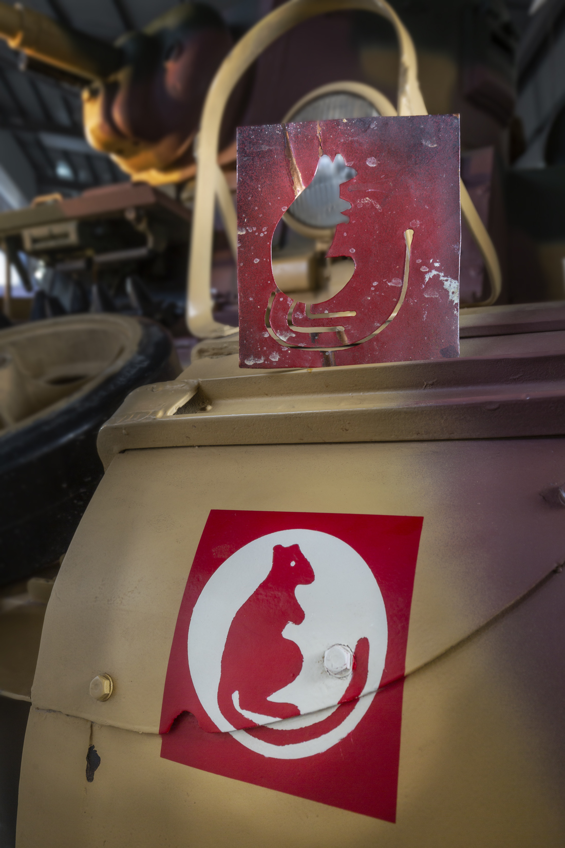 Jerboa stencil in red paint, in a white circle within a red square on The Tank Museum's Stuart tank