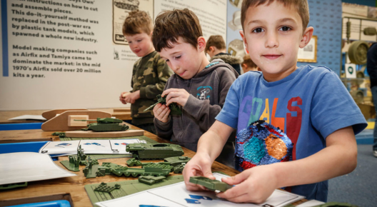 Children's activities Colour picture showing three children making brick models inside the museum.
