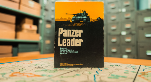 Panzer Leader Picture shows the box Panzer Leader standing upright on the map board. Pictured in the archive room with the background showing filing cabinets.