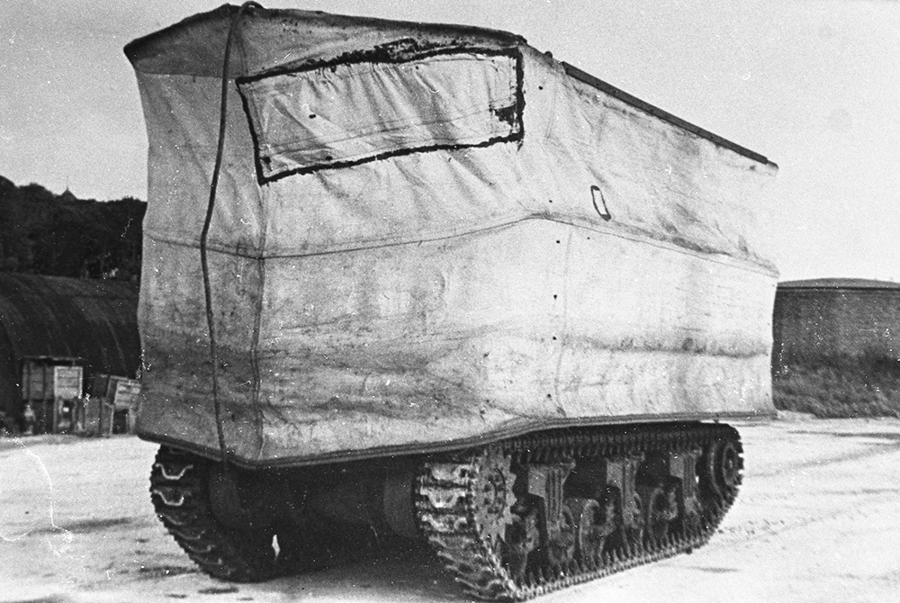 A DD with its skirt raised A black and white photograph of a tank with a canvas screen round it