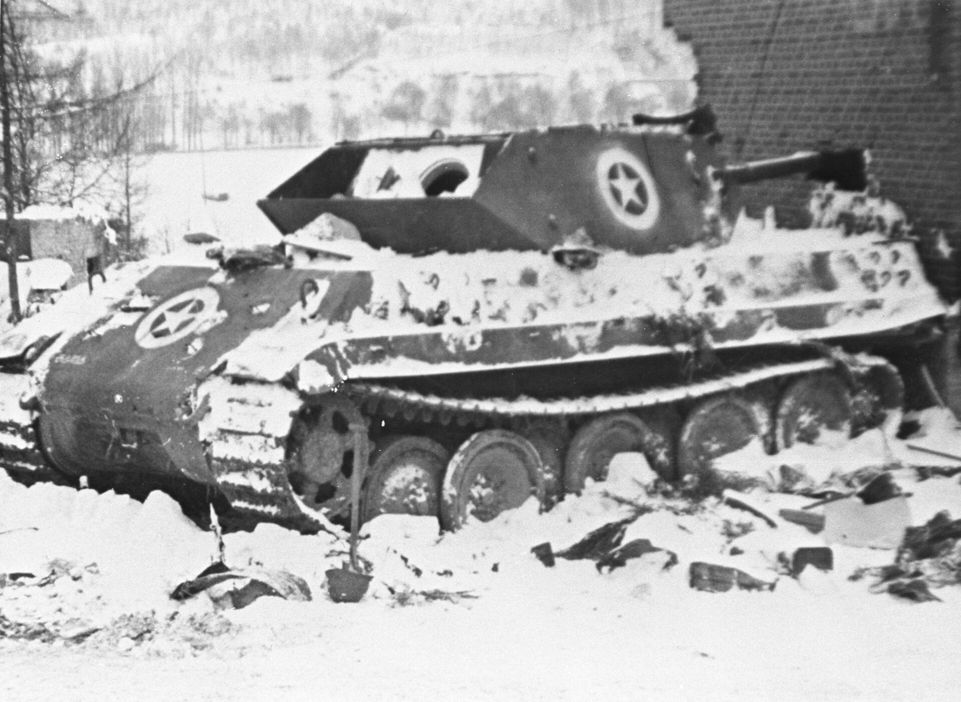 One of Panzer Brigade 150’s disguised Panthers after its loss at Malmedy Black and white photo of a tank.