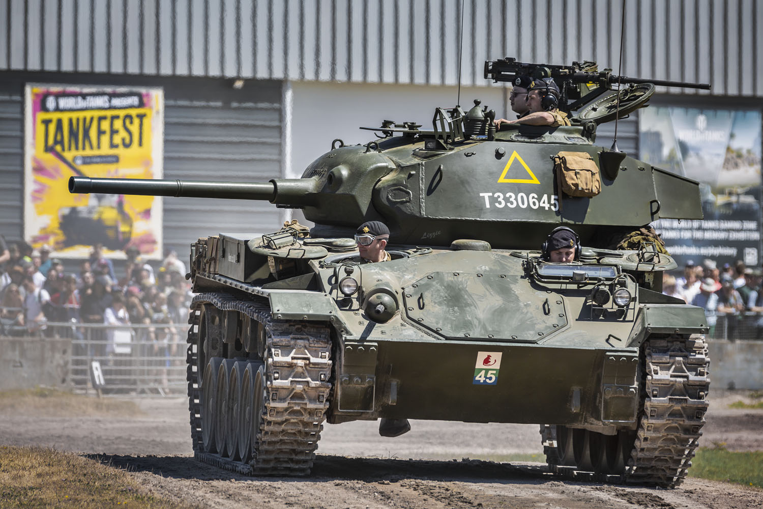 The Bannister Collection's Chaffee at TANKFEST 2024 Photo of a green tank on a mud track, with an audience in the background.