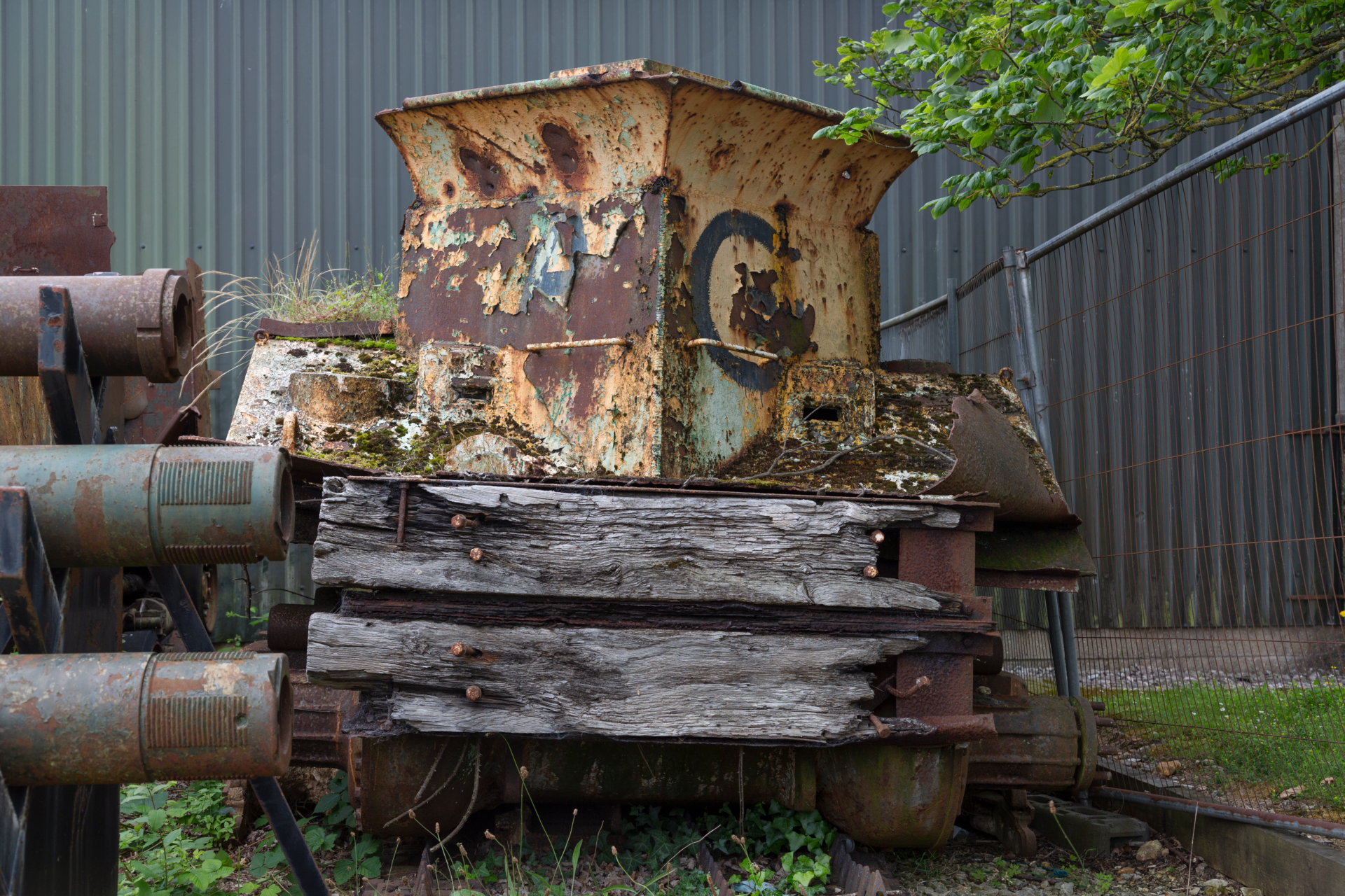 Sherman BARV_006 Photo of a rusted vehicle with wooden panels attached to the front.