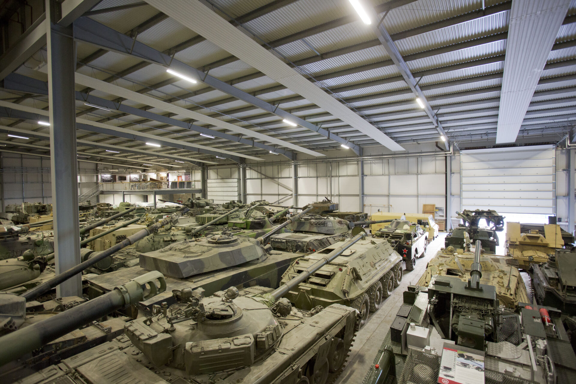VCC 3 Large hangar filled with tanks.
