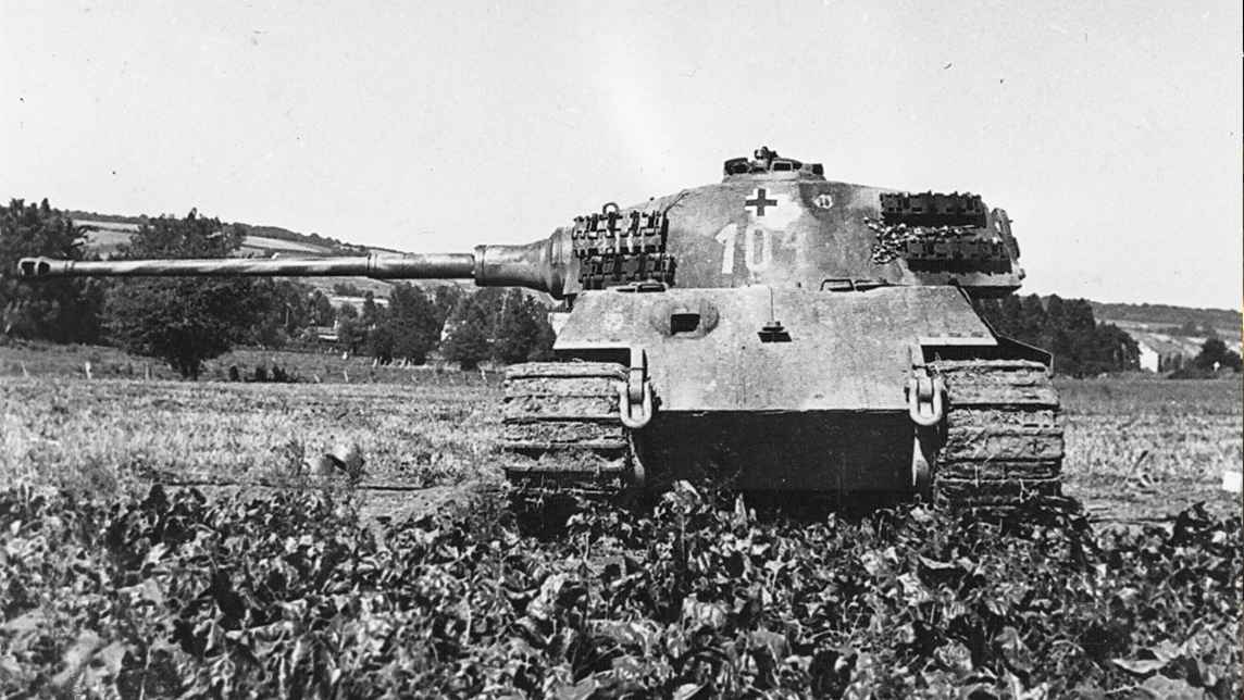 Historic Image - The Tank Museum King Tiger (Article) Black and white photograph of a tank in a field.