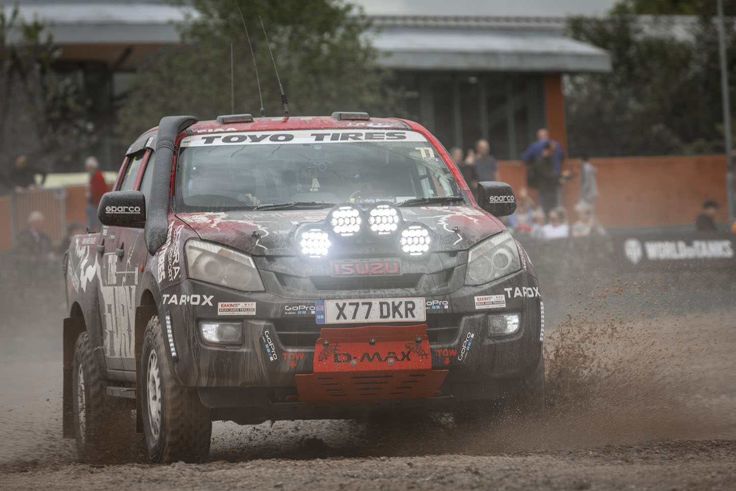 Tracks and Wheels 3 Racing car driving through mud.