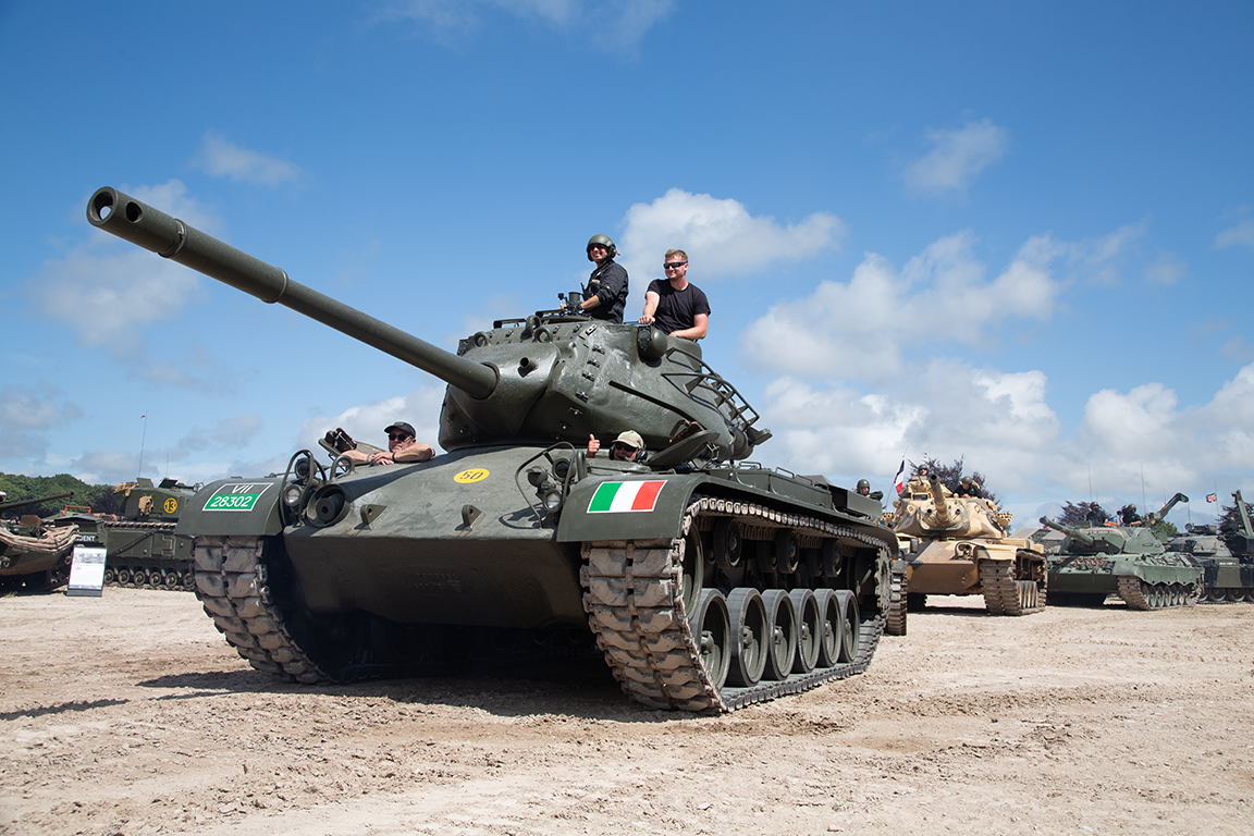 Tankfest 2025_0656 Dark green tank outside under blue skies.