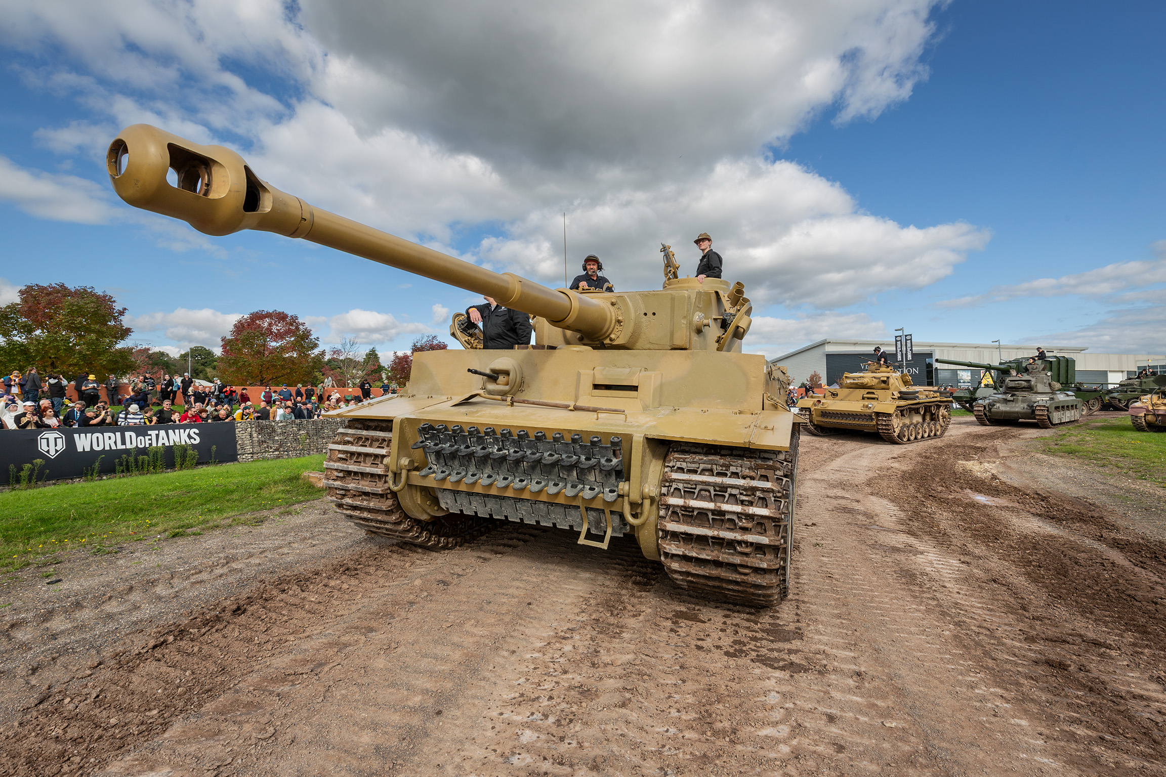 Tiger 131 takes to the arena for Tiger Day Dark yellow tank driving in an arena.
