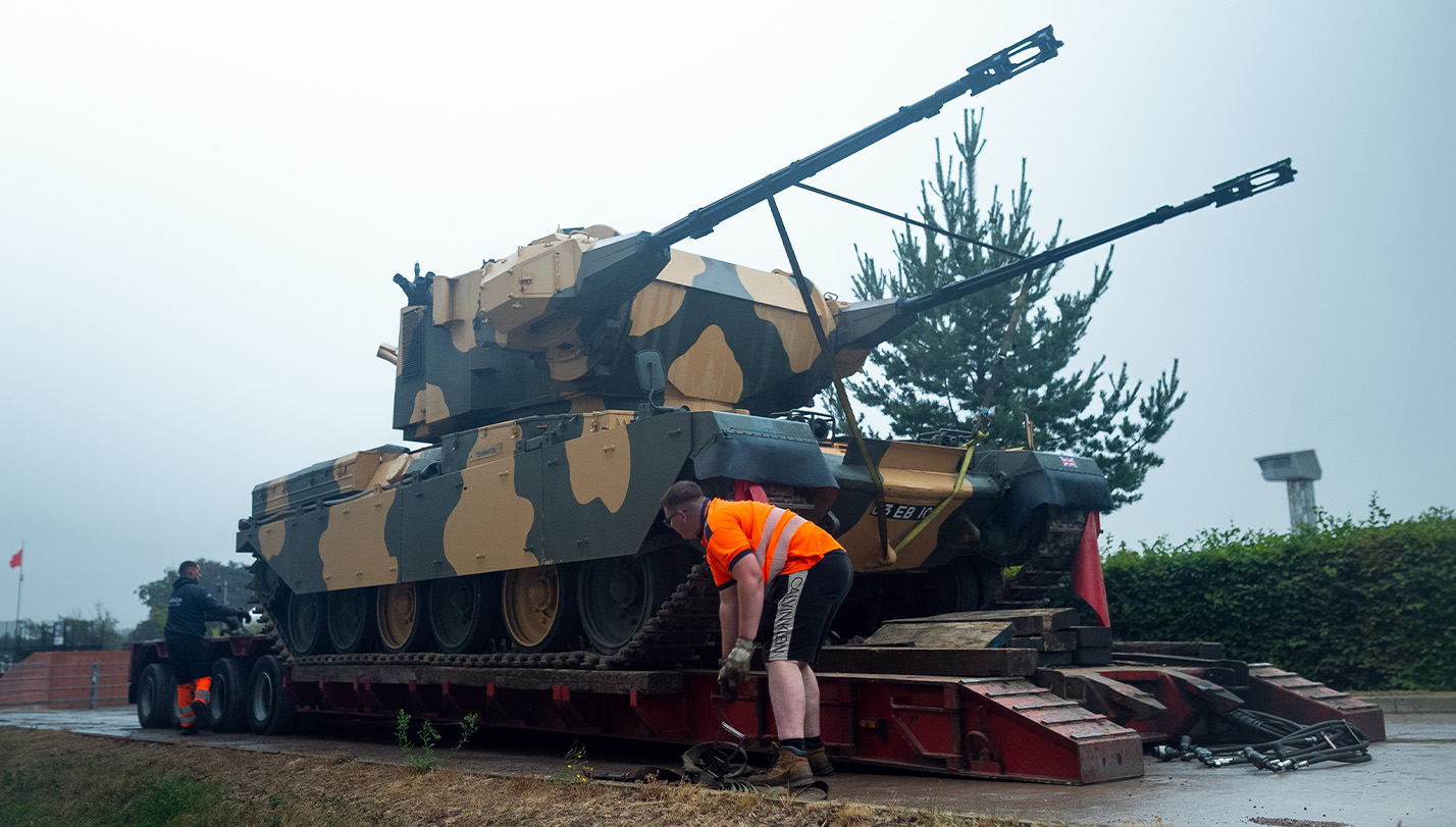 Chieftain Marksman arrival - new additions article Colour photograph showing a Chieftain Marksman tank being unloaded from a truck trailer.